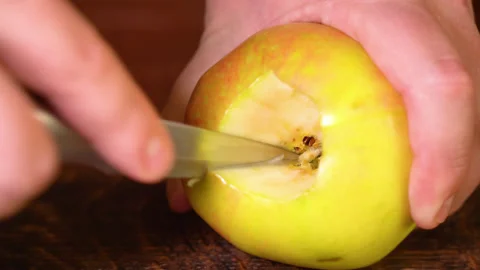 Man peeling an apple in the kitchen Stock Footage 250012601