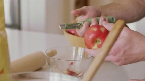 Man peeling apples to bake apple pie Stock Footage 220464692