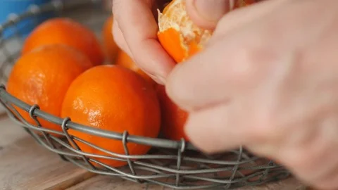 Man peeling clementine Stock Footage 72849877
