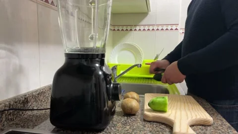 Man peeling cucumber Stock Footage 148940182