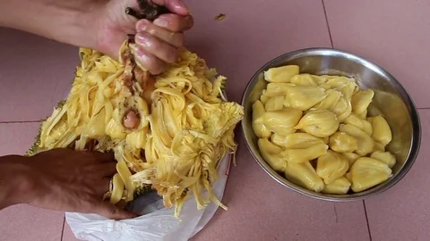 The man is peeling fruit Stock Footage 78250586
