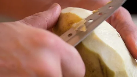 Man peeling half of turnip Stockbeeldmateriaal 121285709
