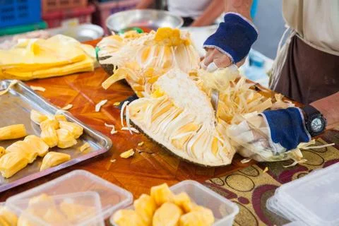 Man is peeling off jackfruit at the wet market Stock Photos