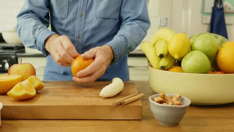 Man Peeling Orange And Adding It In Blender Stock Footage 86073824