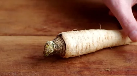 Man peeling parsnip Stock Footage 45883793