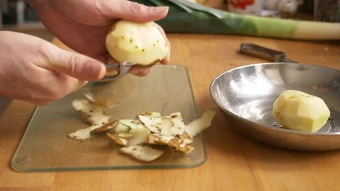 Man peeling a potato Stock Footage 71496168