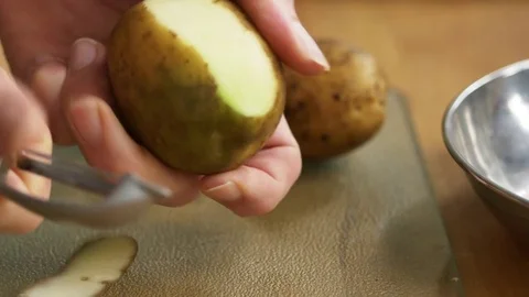 Man peeling a potato Video stock 71496873