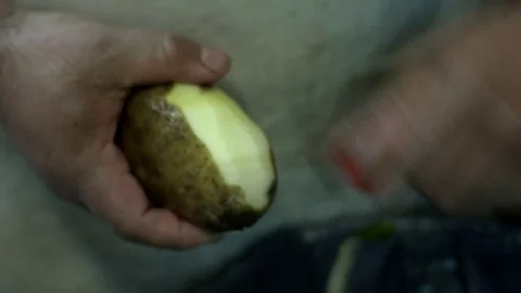 Man peeling potato Video stock 81990305