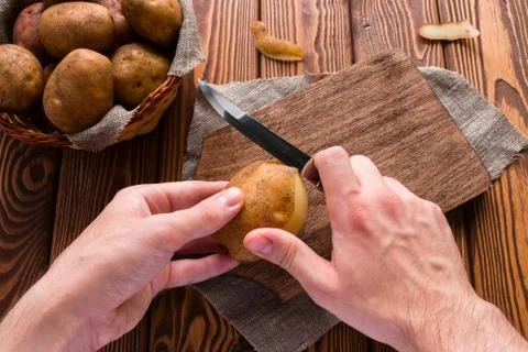 Man peeling potatoes Stock Photos