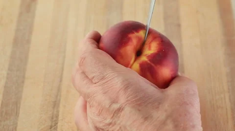 Man peels fresh peach Stock Footage 65796827