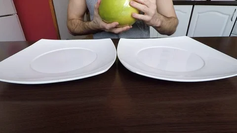 Man peels fruit pomelo Stock Footage 70208519