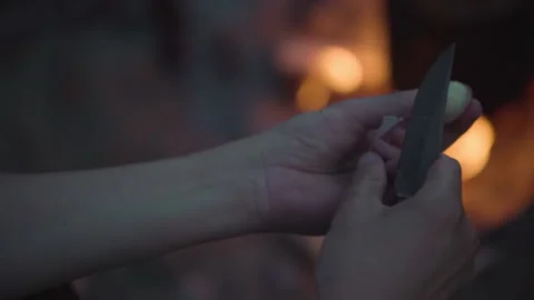 Man peels garlic with a knife Stock Footage 142189455