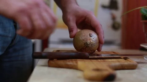 Man Peels The Onions at home kitchen 스톡 동영상 72961733
