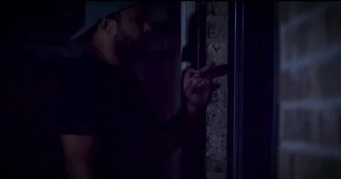 MAN PEEPING THROUGH WINDOW 2 of 7 库存影片 283783061