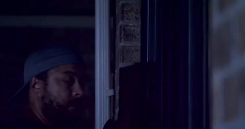 MAN PEEPING THROUGH WINDOW 3 of 7 库存影片 283783138