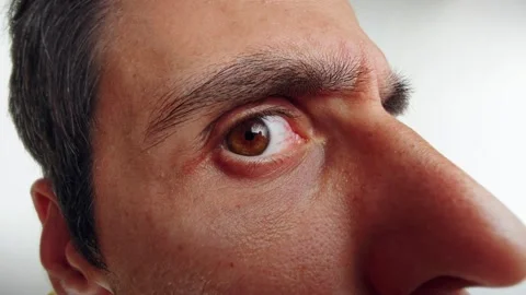 Man Peering Through a Door Viewer with Intense Curiosity Stock Footage 295144924