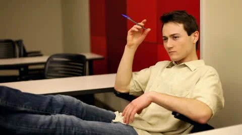 Man with pen in hand sitting in classroom Stock-Footage 10713202