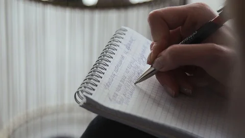 A man of people is writing in a notebook Stock Footage 105483946