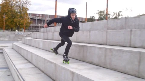 Man perform extreme jumps on inline skates on high stairs Stock Footage 120445546