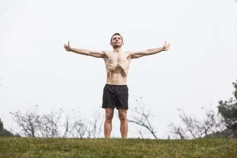 Man performing abdominal exercise on the grass Stock Photos