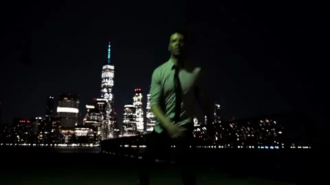 Man Performing Acrobatic Tricking Movement with New York City Skyline Stock Footage 142341030