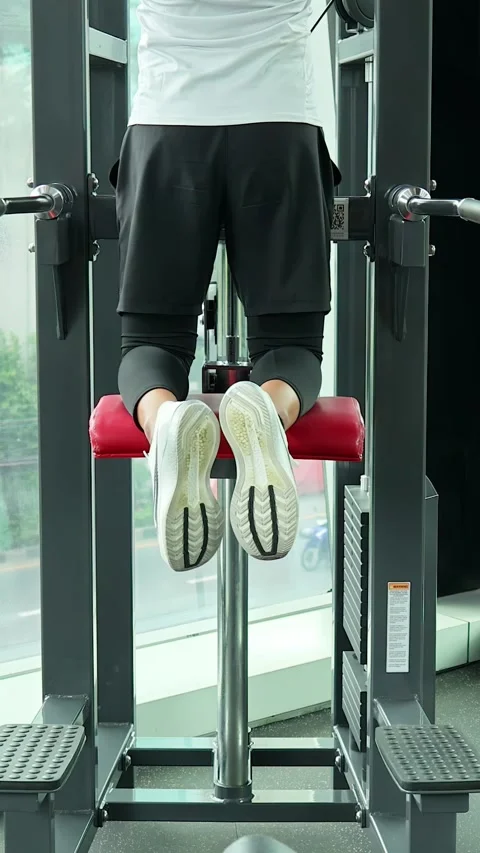 Man Performing Assisted Pull-Ups on Gym Machine Stock Footage 326849527