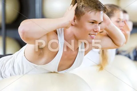 Man Performing Back Extension Exercise In Gym Stock Photos