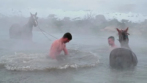Man Performing Backflip into Steaming Thermal Spring in Winter Stock-Footage 329607947