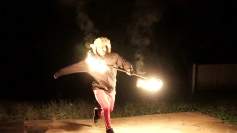 Man Performing Backflip While Spinning Fire Staff in Slow Motion Stock Footage 142341039
