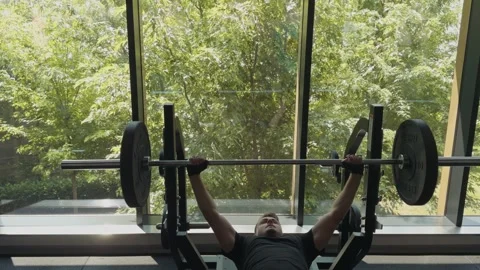 Man performing bench press workout in modern gym Stock Footage 339597141
