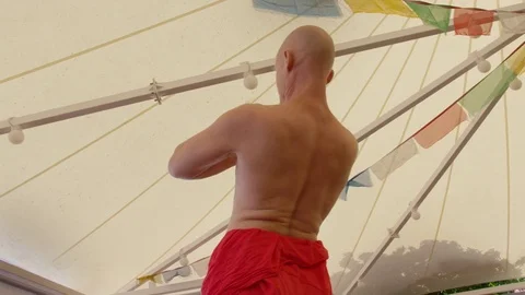 Man performing bridge pose yoga in gazebo Stock Footage 74776304