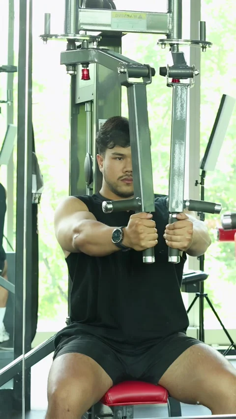 Man Performing Chest Press Exercise on Gym Machine Stock Footage 327767267