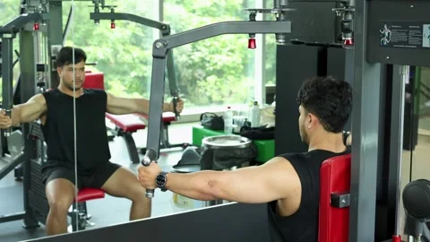 Man Performing Chest Press Exercise on Gym Machine Stock Footage 327767331