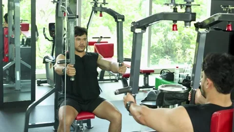 Man Performing Chest Press Exercise on Gym Machine Stock Footage 327767348
