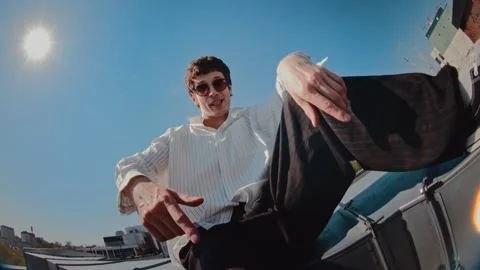 Man performing dance moves with hand gestures and footwork in an outdoor setting Stock Footage 345241301