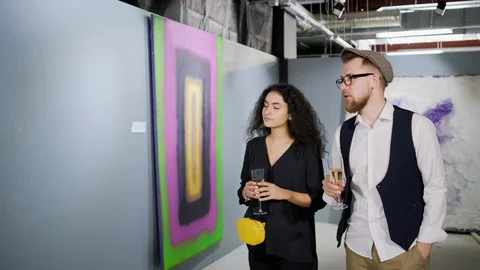 Man is performing excursion in art gallery for pretty brunette woman Stock Footage 112136114