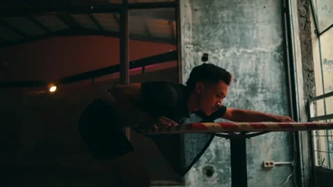 Man Performing an Expressive Dance of Despair on a Table Stock Footage 234860253