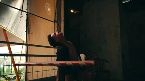Man Performing an Expressive Solo Dance over a Table Stock Footage 234860595