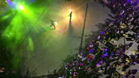 A man is performing a fire trick in front of a crowd Stock-Footage 318096890