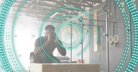 Man performing gym box jumping while turquoise overlay scanning activating Video stock 318173729
