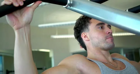 Man Performing Lat Pulldown Exercise at Gym Stock Footage 323776824