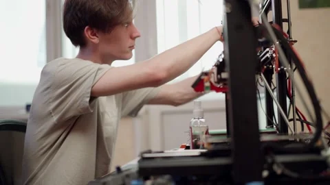 Man performing maintenance of 3d printer Stock Footage 156493765