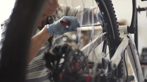 Man is performing maintenance on his mountain bike Stock Footage 277968514