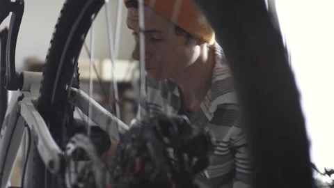 Man is performing maintenance on his mountain bike Stock Footage 277968517