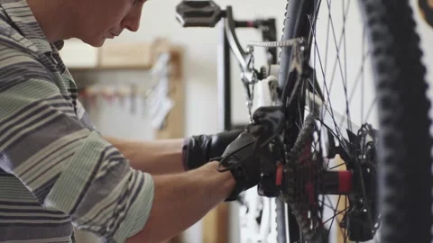 Man is performing maintenance on his mountain bike Stock Footage 277968546