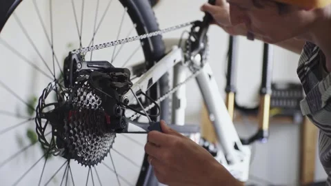 Man is performing maintenance on his mountain bike Stock Footage 277968547