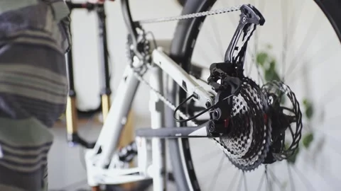 Man is performing maintenance on his mountain bike Stock Footage 277968553