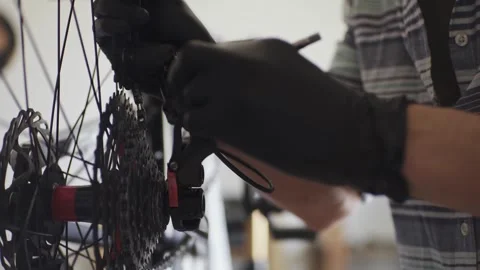 Man is performing maintenance on his mountain bike Stock Footage 277968557