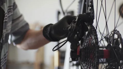 Man is performing maintenance on his mountain bike Stock Footage 277968569