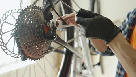 Man is performing maintenance on his mountain bike. Stock Footage 305643060